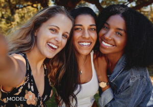 Group of 3 Female Models Smiling and Taking a Selfie