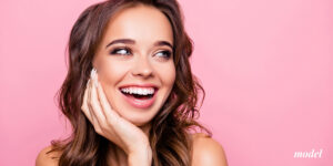 Young Female Model Smiling on Pink Background